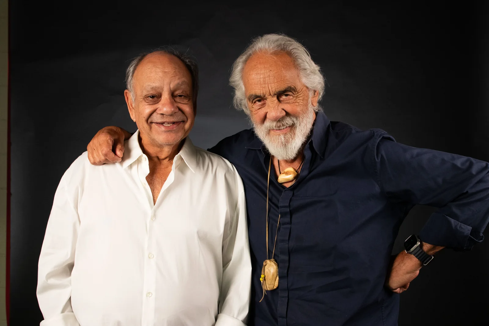 Cheech Marin and Tommy Chong, arm in arm, grinning